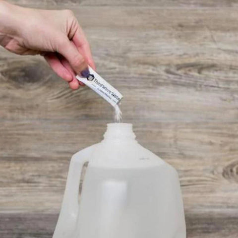 Mixing mineral packet into water for espresso brewing