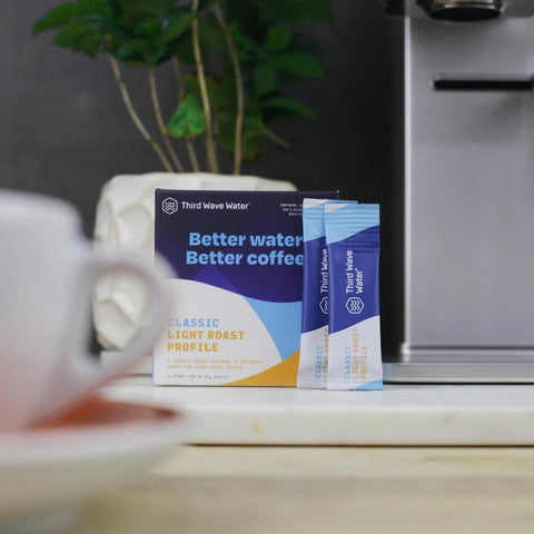 Mineral packet being mixed into water for coffee brewing