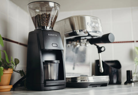 Black Baratza Encore ESP beside an espresso machine